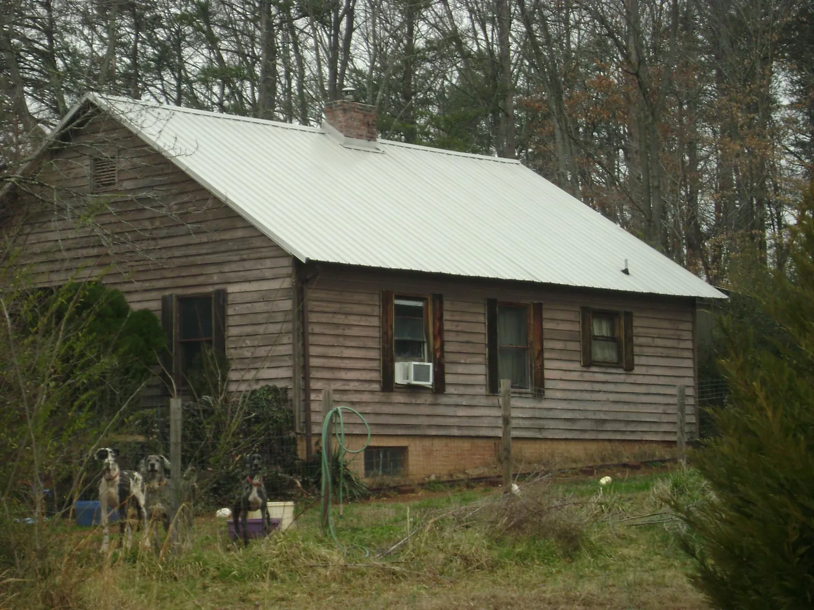 White metal roof on an old wood sided farmhouse, from a Metal Roof Installation job in Baileyton